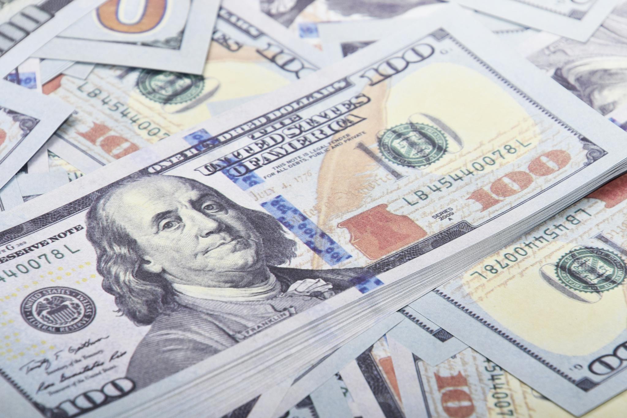 Detailed close-up of United States 100 dollar bills emphasizing currency and finance.